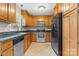 Kitchen featuring wooden cabinets, stainless steel appliances, dark countertops, and a tile floor at 1618 33Rd Ne Ave # 1, Hickory, NC 28601
