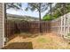 A fenced backyard with a wooden gate and a view of the surrounding townhome community at 1720 Forest Side Ln, Charlotte, NC 28213