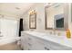 Bathroom features a double sink vanity with two decorative mirrors and tiled floors at 1720 Forest Side Ln, Charlotte, NC 28213