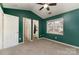 This bedroom has a vaulted ceiling, neutral carpet, ceiling fan, and includes access to a bathroom and closet at 1720 Forest Side Ln, Charlotte, NC 28213