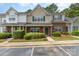 Charming townhome features a brick facade, lush landscaping, and convenient parking at 1720 Forest Side Ln, Charlotte, NC 28213