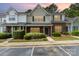 Charming townhome features a brick facade, lush landscaping, and convenient parking at 1720 Forest Side Ln, Charlotte, NC 28213