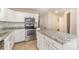 Bright kitchen featuring granite countertops, stainless steel appliances, and a central island at 1720 Forest Side Ln, Charlotte, NC 28213
