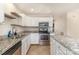 Bright kitchen featuring granite countertops, stainless steel appliances, and a central island at 1720 Forest Side Ln, Charlotte, NC 28213