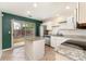 Bright kitchen features an island, granite countertops, stainless steel appliances, and access to the backyard at 1720 Forest Side Ln, Charlotte, NC 28213