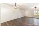 Bright living room with wood floors, fan, and ample natural light at 1720 Forest Side Ln, Charlotte, NC 28213