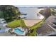 Aerial view of the lakefront condominium complex featuring a swimming pool, beach, and docks at 17810 Half Moon Ln # L, Cornelius, NC 28031