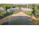 Aerial view of lakeside condominiums with a sandy beach, lake access, and pier at 17810 Half Moon Ln # L, Cornelius, NC 28031