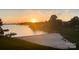 A tranquil sunset over the lake and sandy beach, perfect for enjoying evening relaxation at 17810 Half Moon Ln # L, Cornelius, NC 28031