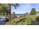 Tranquil lake view with private community beach access and inviting landscaped grounds at 17810 Half Moon Ln # L, Cornelius, NC 28031