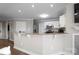 Well-appointed kitchen with a bar area, granite countertops and stainless steel appliances at 17810 Half Moon Ln # L, Cornelius, NC 28031