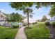 Beautiful landscaped path to the lakefront beach and pool surrounded by tropical palms at 17810 Half Moon Ln # L, Cornelius, NC 28031