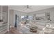 Bright living room with a sectional sofa, a sliding glass door with a beautiful lake view, and modern decor at 17810 Half Moon Ln # L, Cornelius, NC 28031