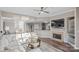 Open-concept living area with a fireplace, modern decor, and seamless flow to the dining and kitchen areas at 17810 Half Moon Ln # L, Cornelius, NC 28031