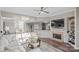 Open-concept living area with a fireplace, modern decor, and seamless flow to the dining and kitchen areas at 17810 Half Moon Ln # L, Cornelius, NC 28031