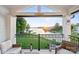 Relaxing patio overlooking a lake, with comfortable seating and a serene waterfront view at 17810 Half Moon Ln # L, Cornelius, NC 28031