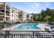 Community pool with lounge chairs and beautiful landscaping, perfect for relaxation at 17810 Half Moon Ln # L, Cornelius, NC 28031