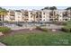 A resort style outdoor condominium pool with lounge seating surrounded by tropical landscaping at 17810 Half Moon Ln # L, Cornelius, NC 28031
