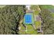 Aerial view of a community tennis court surrounded by trees and parking at 17810 Half Moon Ln # L, Cornelius, NC 28031