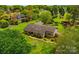 Aerial view of a brick home with a landscaped yard surrounded by mature trees and greenery at 189 Billy Jo Rd, Mooresville, NC 28117