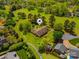 Aerial view showcasing a landscaped home surrounded by lush trees and green lawns in a golf community at 189 Billy Jo Rd, Mooresville, NC 28117