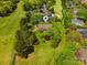 Aerial view of the home in a verdant, tree-lined neighborhood near the water at 189 Billy Jo Rd, Mooresville, NC 28117
