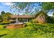 Exterior view of a brick house from the landscaped yard featuring a fountain at 189 Billy Jo Rd, Mooresville, NC 28117
