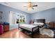 A charming bedroom features a large window, hardwood floors, and a ceiling fan at 189 Billy Jo Rd, Mooresville, NC 28117