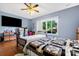 A lovely bedroom features hardwood floors, ceiling fan, and a large window at 189 Billy Jo Rd, Mooresville, NC 28117