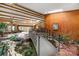 Stunning foyer with pond, wood-paneled walls, beamed ceiling and bridge at 189 Billy Jo Rd, Mooresville, NC 28117