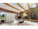 Living room with a large stone fireplace, beamed ceilings, and sliding doors to an outdoor area at 189 Billy Jo Rd, Mooresville, NC 28117