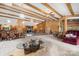 Open-concept living area with dining table, interior pond, beamed ceilings, and natural light throughout at 189 Billy Jo Rd, Mooresville, NC 28117