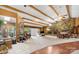 Spacious living room with a stone fireplace, exposed beams, and large windows to allow for plenty of natural light at 189 Billy Jo Rd, Mooresville, NC 28117