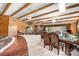 A spacious living area with a dining table, an indoor pond, beam ceilings, and natural lighting at 189 Billy Jo Rd, Mooresville, NC 28117