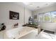 Large soaking tub is set into a tiled surround and features a bright window at 189 Billy Jo Rd, Mooresville, NC 28117