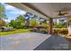 Covered patio and landscaped backyard featuring a fountain at 189 Billy Jo Rd, Mooresville, NC 28117