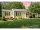 Charming one-story home with manicured lawn and flowering bushes at 204 Myers St, Fort Mill, SC 29715