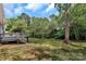 Backyard view with deck, showcasing spacious lawn and mature shade trees at 205 Mcgregor Rd, Gastonia, NC 28056