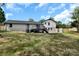 Expansive backyard view featuring a deck, lush lawn, and mature trees at 205 Mcgregor Rd, Gastonia, NC 28056