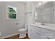 Updated bathroom with modern vanity, white cabinets, vinyl floor, and bright natural light at 205 Mcgregor Rd, Gastonia, NC 28056