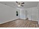 Bright bedroom features luxury vinyl flooring, a ceiling fan, and a window with tree views at 205 Mcgregor Rd, Gastonia, NC 28056