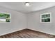Bright bedroom featuring two windows and wood-look flooring at 205 Mcgregor Rd, Gastonia, NC 28056
