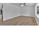 Bright bedroom featuring new floors, neutral paint, ceiling fan, and large windows at 205 Mcgregor Rd, Gastonia, NC 28056