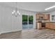 Bright dining room adjacent to kitchen, and sliding door out to the deck at 205 Mcgregor Rd, Gastonia, NC 28056