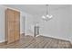 Bright dining room features modern chandelier, luxury vinyl flooring, and convenient built-in storage cabinet at 205 Mcgregor Rd, Gastonia, NC 28056