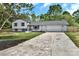 Front exterior view shows a home with two-car garage and large front yard at 205 Mcgregor Rd, Gastonia, NC 28056