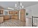 Charming kitchen featuring modern appliances, warm cabinetry, and new floors at 205 Mcgregor Rd, Gastonia, NC 28056