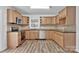 Charming kitchen featuring modern appliances, warm cabinetry, and new floors at 205 Mcgregor Rd, Gastonia, NC 28056