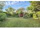 Serene backyard features a swing among beautiful trees and manicured landscaping, providing relaxation at 2110 Cool Springs Ct, Kannapolis, NC 28083