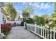 Inviting backyard patio area with outdoor dining set and beautiful flower garden with white picket fence at 2110 Cool Springs Ct, Kannapolis, NC 28083
